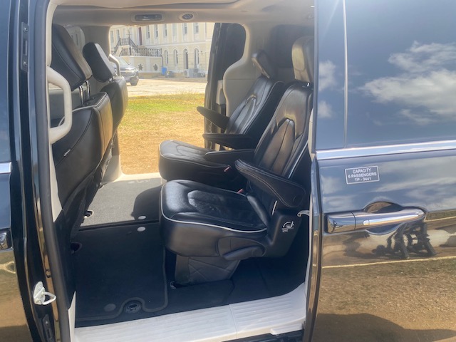 Clean leather passenger seating inside the taxi minivan