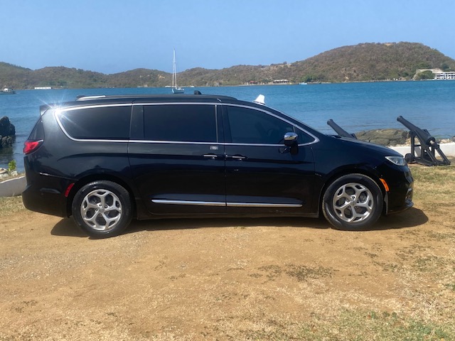 Passenger side of the black Chrysler Pacifica taxi