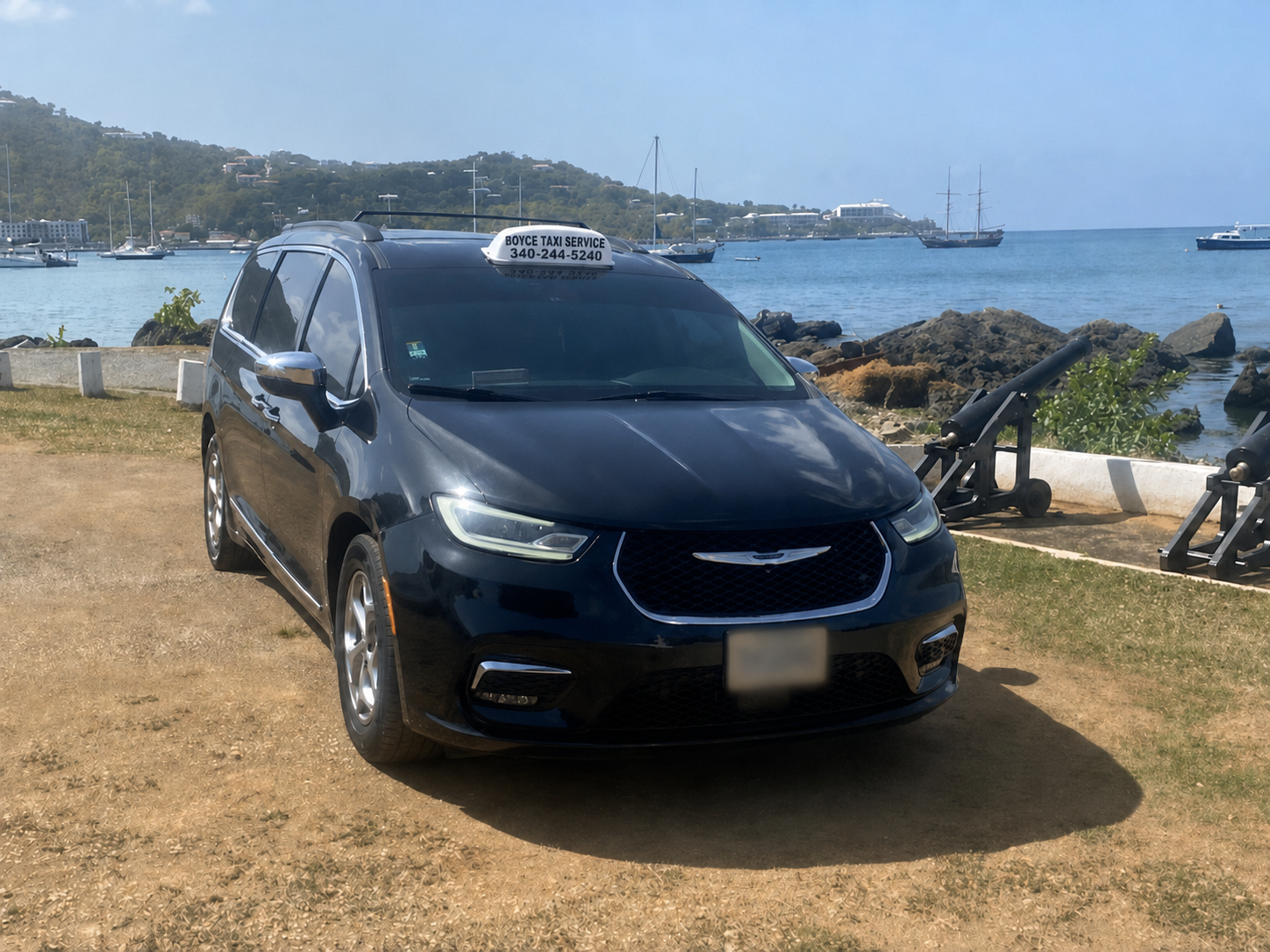 Boyce Taxi Service minivan with roof sign and St. Thomas waterfront